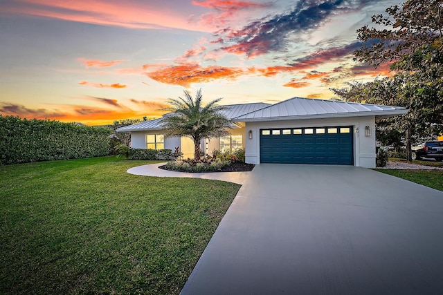 view of front of house featuring a lawn and a garage