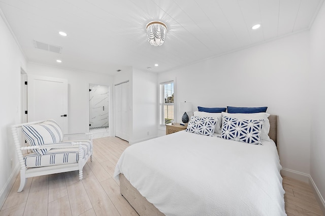 bedroom with light wood-type flooring, ensuite bathroom, a closet, and ornamental molding