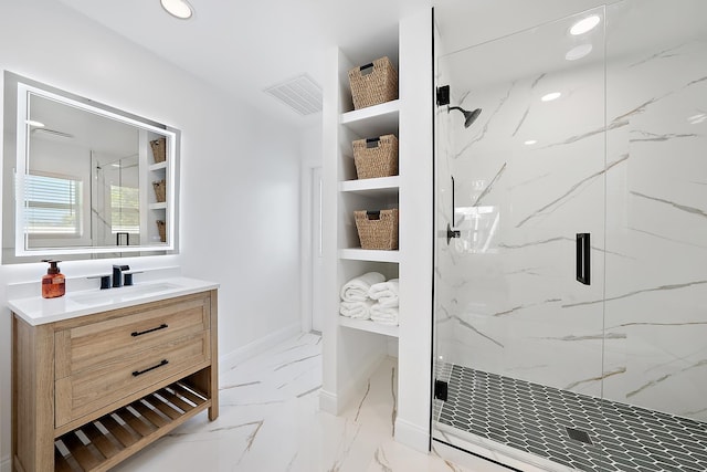 bathroom with vanity and a shower with door