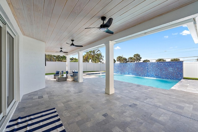 view of pool featuring pool water feature, ceiling fan, a patio area, and outdoor lounge area