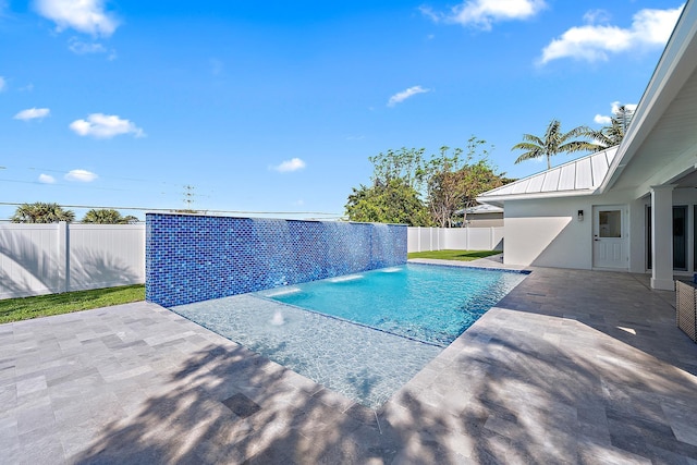 view of swimming pool with a patio area and pool water feature