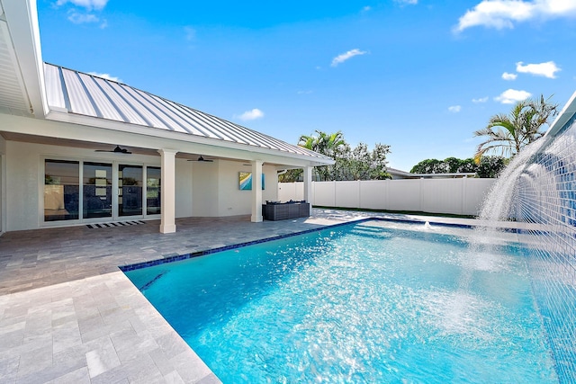 view of swimming pool with an outdoor hangout area, pool water feature, ceiling fan, and a patio area