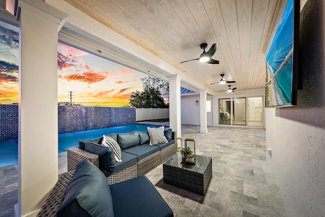 view of patio with an outdoor living space and ceiling fan