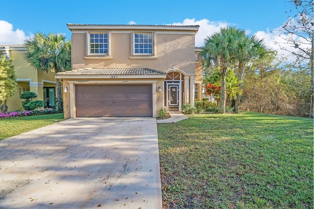 mediterranean / spanish home featuring a garage and a front lawn