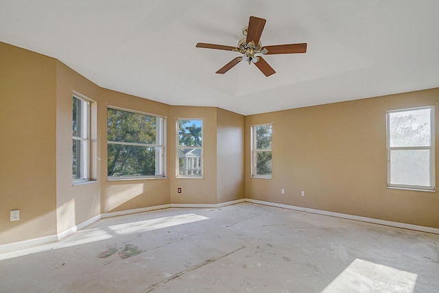 unfurnished room with a tray ceiling and ceiling fan