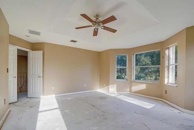 unfurnished room with a raised ceiling and ceiling fan