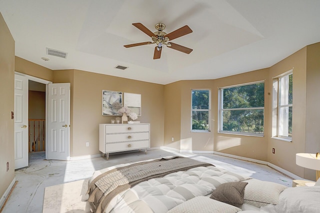 bedroom featuring a raised ceiling and ceiling fan