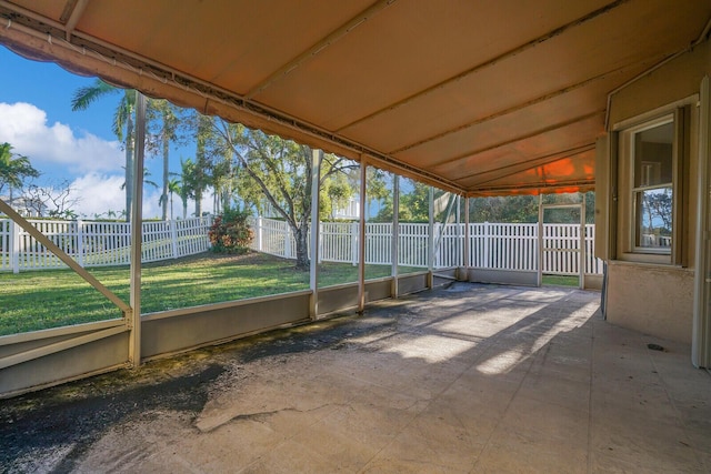 unfurnished sunroom featuring lofted ceiling