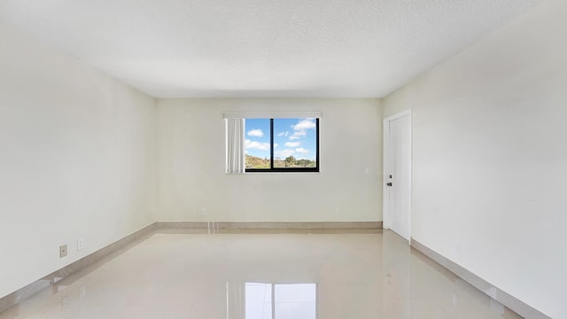 empty room with a textured ceiling