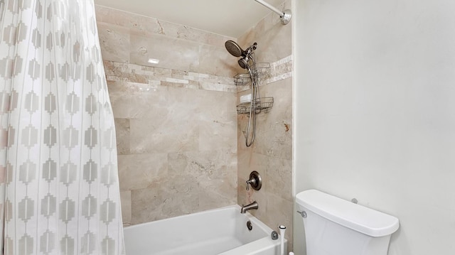 bathroom featuring toilet and tiled shower / bath