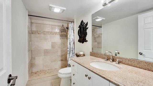 bathroom with tile patterned floors, vanity, toilet, and walk in shower