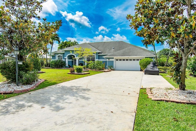 ranch-style house featuring a garage and a front lawn