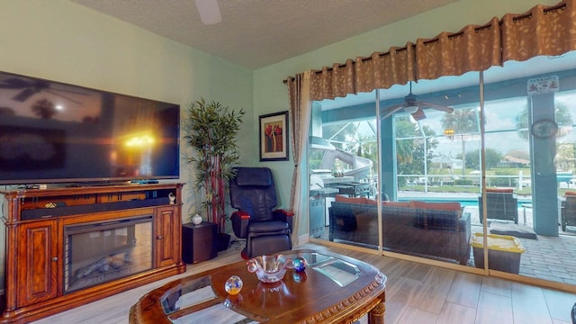 living room featuring light hardwood / wood-style floors and a textured ceiling