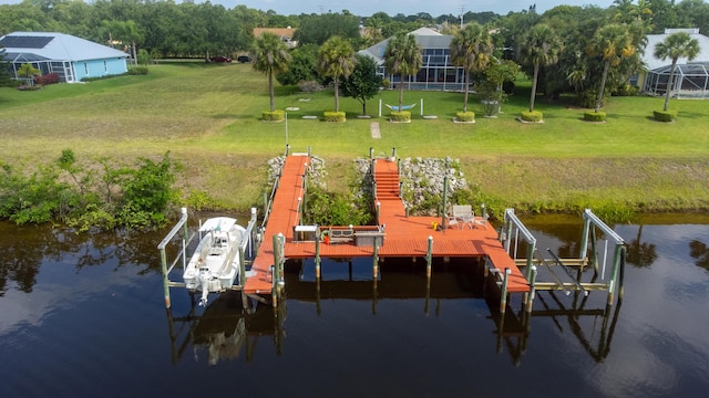 dock area with a water view and a lawn