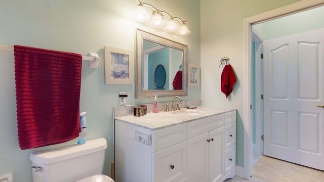 bathroom with tile patterned floors, vanity, and toilet