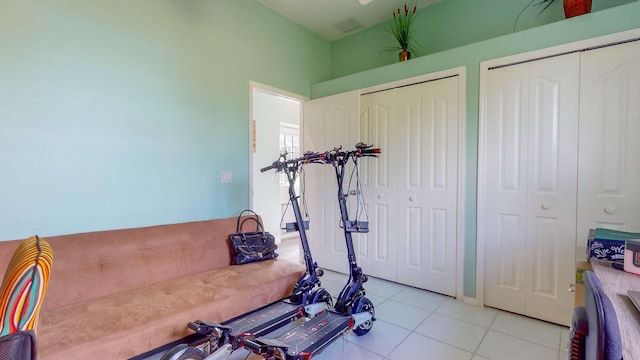 workout area featuring light tile patterned flooring