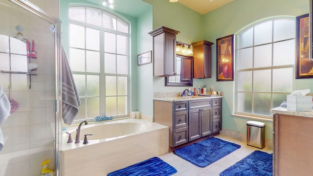 bathroom featuring shower with separate bathtub, vanity, tile patterned floors, and a wealth of natural light