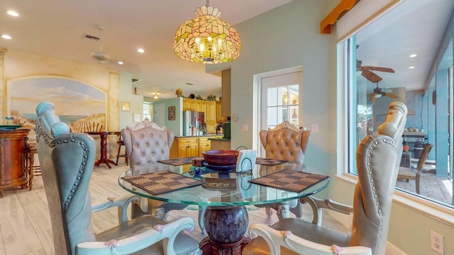 dining space featuring ceiling fan and light hardwood / wood-style flooring