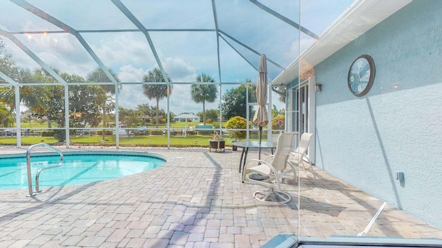 view of swimming pool with a lanai and a patio area