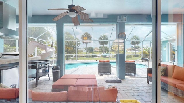 interior space with ceiling fan and a swimming pool