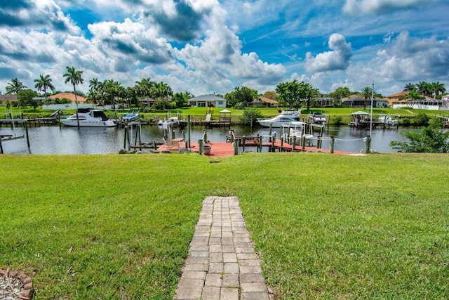 view of dock with a yard and a water view