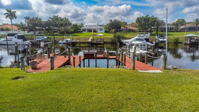 view of dock with a yard and a water view