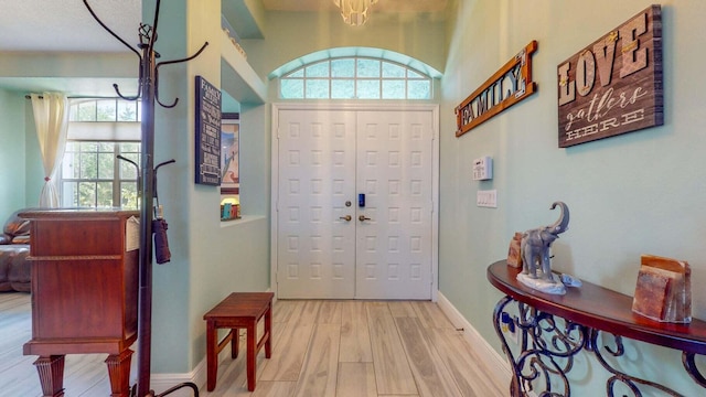 foyer featuring a wealth of natural light and light hardwood / wood-style floors