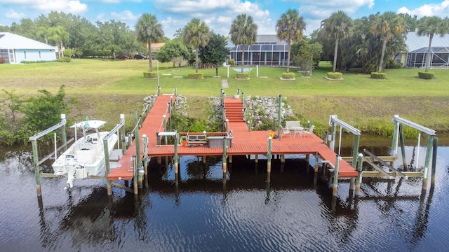 view of dock featuring a yard and a water view