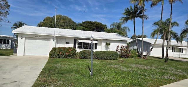 single story home with a front yard and a garage