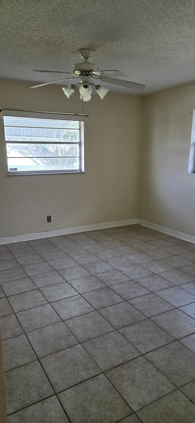 unfurnished room with plenty of natural light and light tile patterned floors