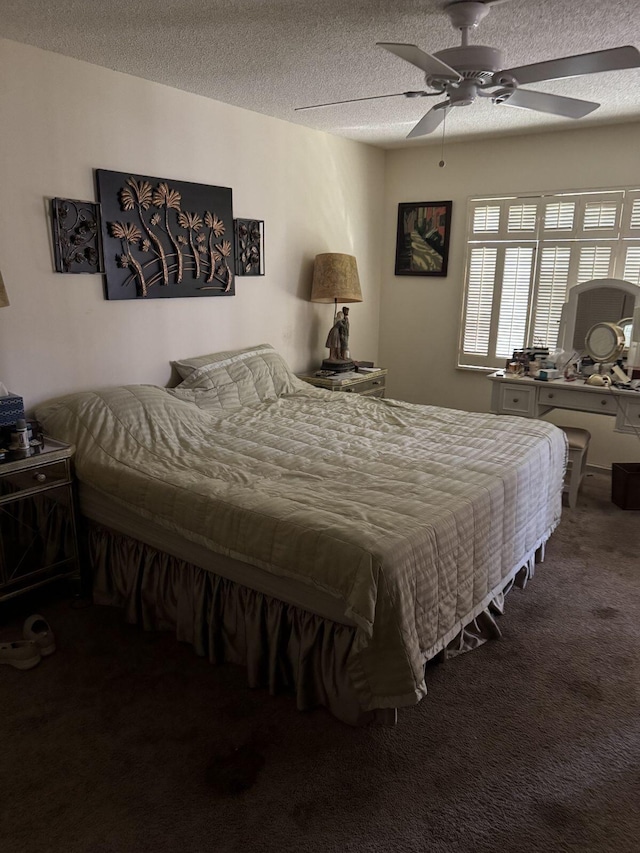 carpeted bedroom with ceiling fan and a textured ceiling