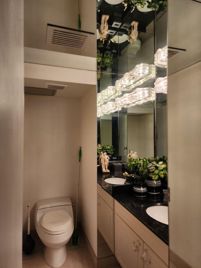 bathroom with tile patterned floors, vanity, and toilet