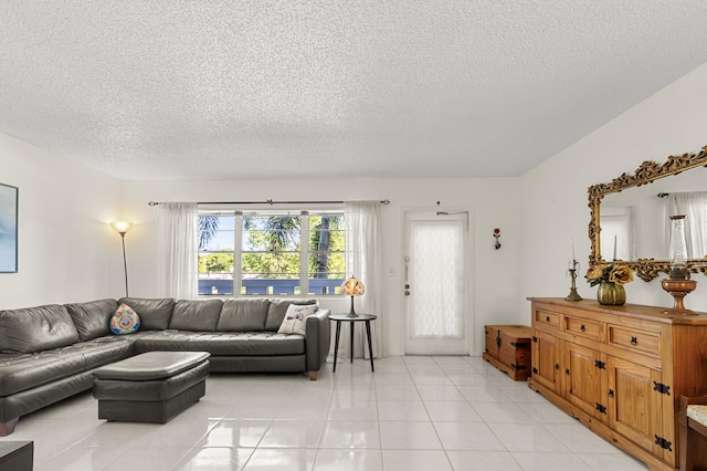 living room featuring a textured ceiling and light tile patterned flooring