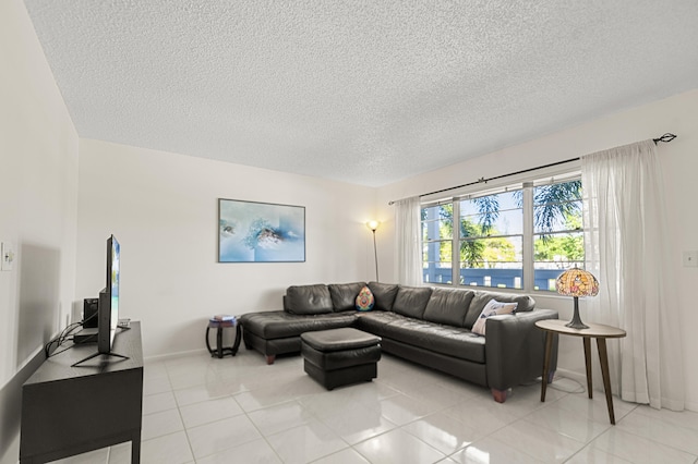 living room featuring light tile patterned flooring and a textured ceiling