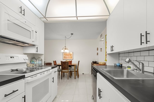 kitchen featuring a chandelier, white appliances, white cabinetry, and hanging light fixtures