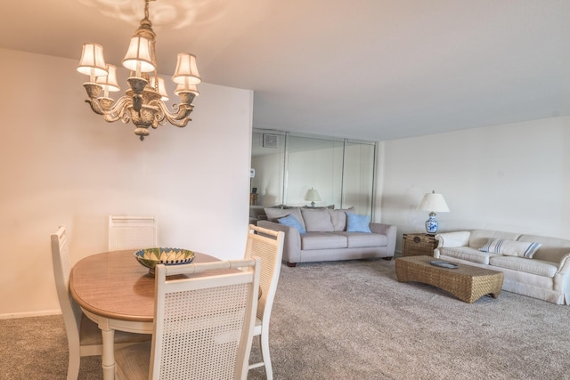 dining room with carpet floors and an inviting chandelier