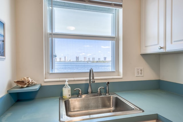 kitchen with white cabinetry and sink