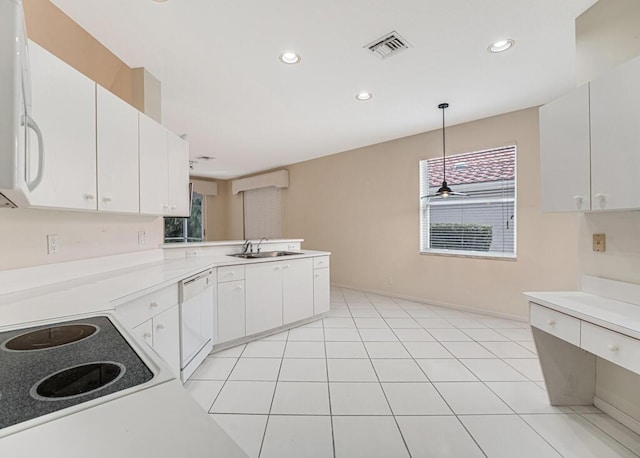 kitchen with sink, decorative light fixtures, white cabinetry, and dishwasher