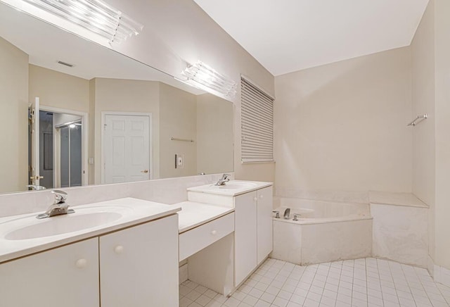 bathroom featuring a relaxing tiled tub, tile patterned floors, and vanity