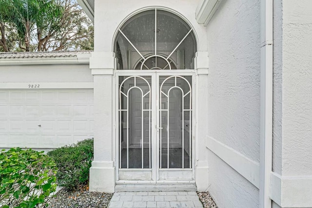 doorway to property with a garage