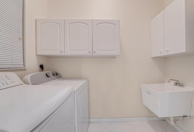 washroom with washer and dryer, cabinets, light tile patterned flooring, and sink