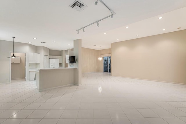 kitchen featuring white fridge with ice dispenser, a chandelier, hanging light fixtures, white cabinetry, and light tile patterned flooring