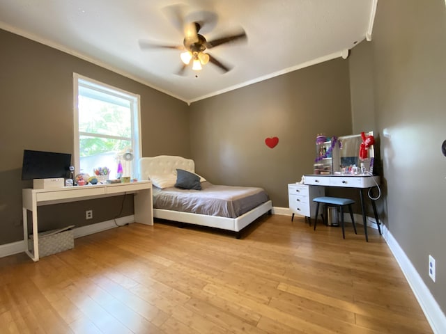 bedroom with ceiling fan, light wood-type flooring, and crown molding