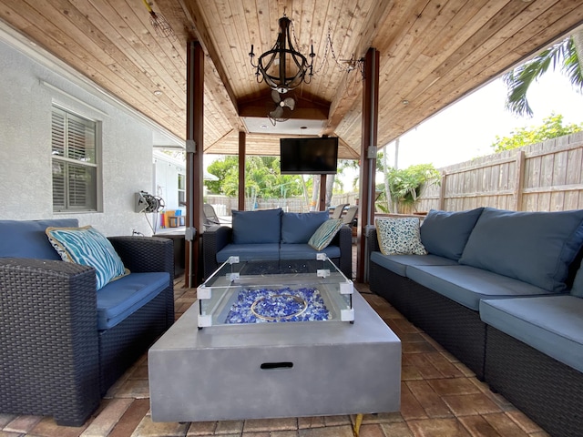 view of patio with an outdoor living space with a fire pit