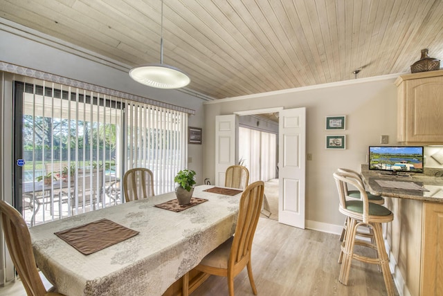 dining space featuring light hardwood / wood-style flooring, wooden ceiling, and crown molding