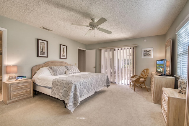 bedroom with light carpet, access to outside, a ceiling fan, and a textured ceiling