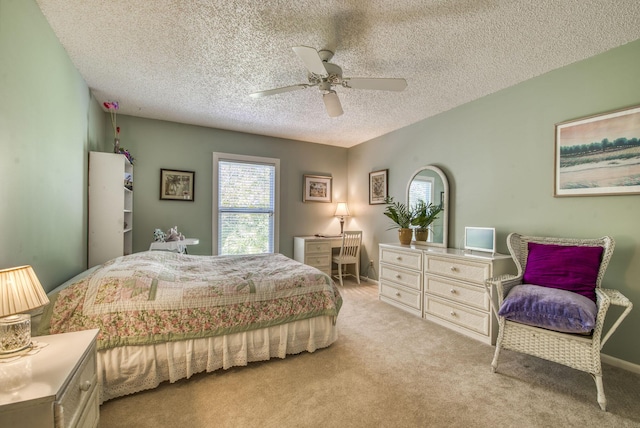 carpeted bedroom featuring ceiling fan and a textured ceiling