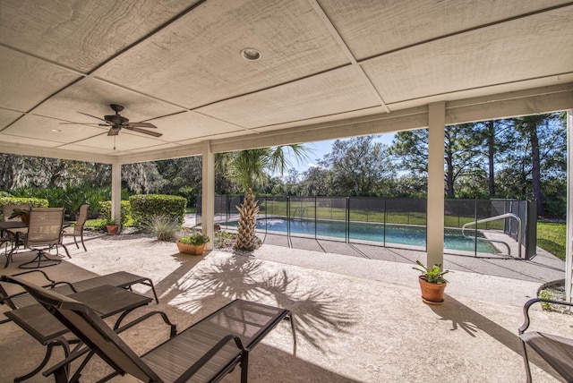 view of patio with a ceiling fan, fence, and outdoor dining space