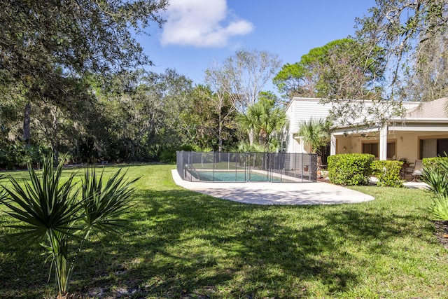 view of yard with a fenced in pool and a patio area