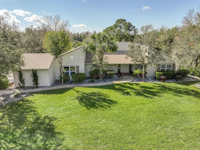 view of front of property with a front lawn and roof with shingles